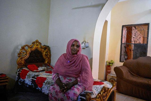 Local resident Nosayba Saad speaks to an AFP journalist at her home on Khartoum's Tuti island on April 17, 2026. Located where the White Nile, flowing from Uganda, meets the Blue Nile from Ethiopia, Tuti is across the river from where war first broke out in April 2023, between Sudan's army and the paramilitary Rapid Support Forces. In recent months, many residents have returned home to the island, besieged from June 2023 until March 2025, when the army recaptured Sudan's capital. (Photo by Khaled DESOUKI / AFP)