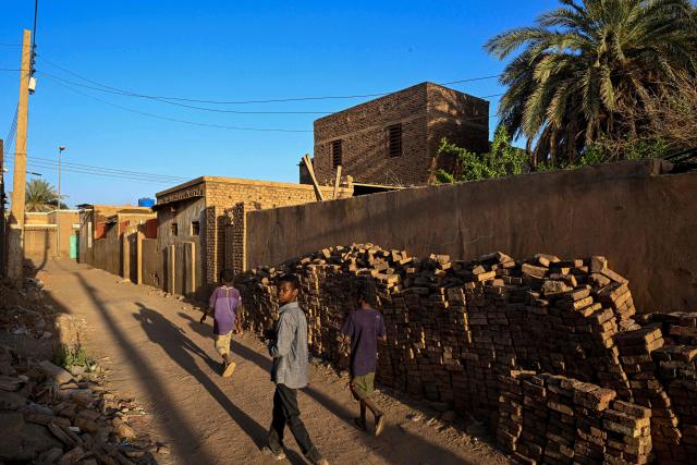 Sudanese children stroll through an alley on Khartoum's Tuti island on April 17, 2026. Located where the White Nile, flowing from Uganda, meets the Blue Nile from Ethiopia, Tuti is across the river from where war first broke out in April 2023, between Sudan's army and the paramilitary Rapid Support Forces. In recent months, many residents have returned home to the island, besieged from June 2023 until March 2025, when the army recaptured Sudan's capital. (Photo by Khaled DESOUKI / AFP)