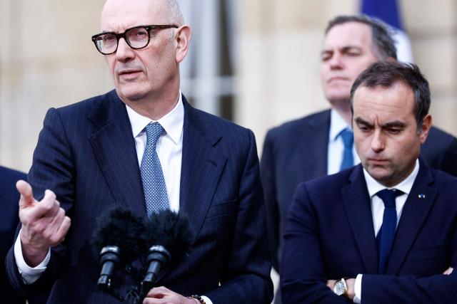 France's Economy, Finances and Industry Minister Roland Lescure (L), flanked by France's Prime Minister Sebastien Lecornu (R), delivers a speech in front of the press following a government meeting focused on energy at the Hotel de Matignon in Paris on April 21, 2026. (Photo by Kenzo TRIBOUILLARD / AFP)