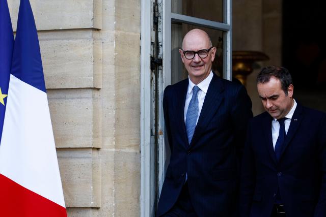 France's Economy, Finances and Industry Minister Roland Lescure (L) and France's Prime Minister Sebastien Lecornu speak together as they arrive for a press briefing following a government meeting focused on energy at the Hotel de Matignon in Paris on April 21, 2026. (Photo by Kenzo TRIBOUILLARD / AFP)