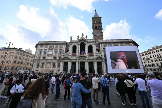 People follow a Mass on a giant screen on the first anniversary of Pope Francis’s death at the Papal Basilica of Santa Maria Maggiore in Rome on April 21, 2026. (Photo by Tiziana FABI / AFP)