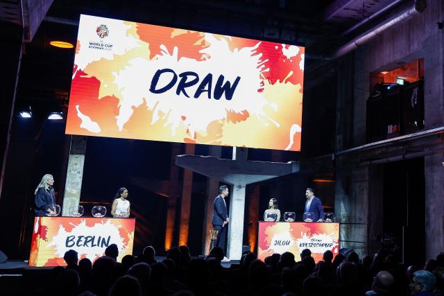 German handball player Stefan Kretzschmar (R) and German breakdancer Bgirl Jilou (2nd R) prepare to take part in the FIBA Women's Basketball 2026 World Cup draw in Berlin on April 21, 2026. (Photo by Odd ANDERSEN / AFP)