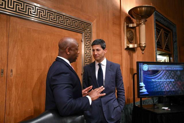Kevin Warsh (R), nominee for US Federal Reserve Chair, speaks with committee chairman US Senator Tim Scott, Republican from South Carolina, at the end of a Senate Banking Committee hearing on Warsh's nomination on Capitol Hill in Washington, DC, on April 21, 2026. Warsh, President Donald Trump's choice to lead the US Federal Reserve, vowed Tuesday to protect central bank independence at his confirmation hearing, despite intense pressure from the president. (Photo by Mandel NGAN / AFP)