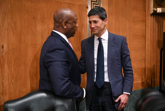 Kevin Warsh (R), nominee for US Federal Reserve Chair, speaks with committee chairman US Senator Tim Scott, Republican from South Carolina, at the end of a Senate Banking Committee hearing on Warsh's nomination on Capitol Hill in Washington, DC, on April 21, 2026. Warsh, President Donald Trump's choice to lead the US Federal Reserve, vowed Tuesday to protect central bank independence at his confirmation hearing, despite intense pressure from the president. (Photo by Mandel NGAN / AFP)