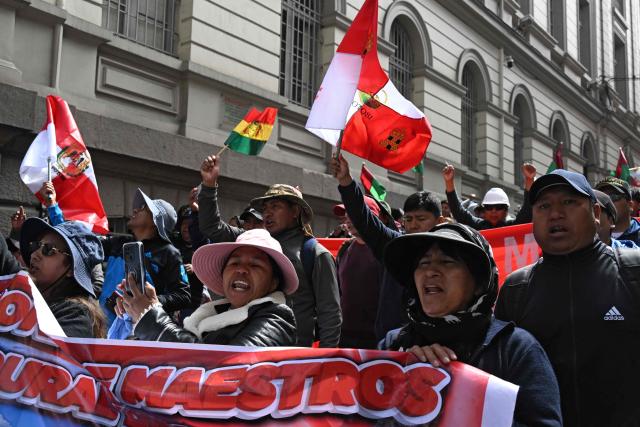 Rural education workers shout slogans as they march through the central streets of La Paz on April 21, 2026, demanding a wage increase for their sector. (Photo by Aizar RALDES / AFP)