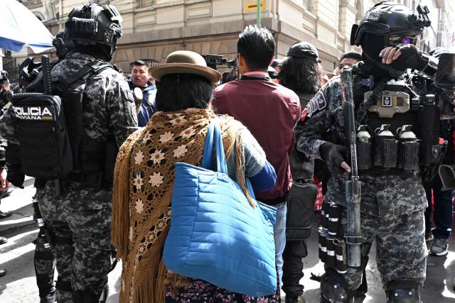 Riot police guard the Plaza Murillo during a rural education workers march through the central streets of La Paz on April 21, 2026, in demand of a wage increase for their sector. (Photo by Aizar RALDES / AFP)