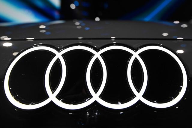 The logo of German carmaker AUDI is pictured on a new AUDI A6L e-tron electric car model during its presentation at an event ahead of the Beijing Auto Show 2026 in Beijing on April 21, 2026. (Photo by Pedro PARDO / AFP)