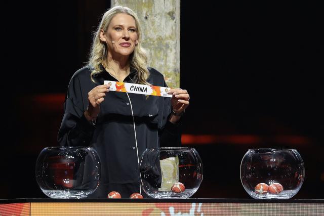 Lauren Jackson, Australian former basketball player, draws China out of the pot to go in to Group D during the FIBA Women's Basketball 2026 World Cup draw in Berlin on April 21, 2026. (Photo by Odd ANDERSEN / AFP)