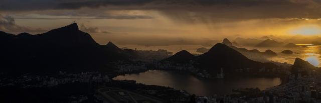 Aerial view shows the Christ the Redeemer statue on Corcovado mountain in the Tijuca Forest National Park (L), the Rodrigo de Freitas Lagoon (front) and Guanabara bay (behind) in Rio de Janeiro, Brazil on April 21, 2026. (Photo by Pablo PORCIUNCULA / AFP)
