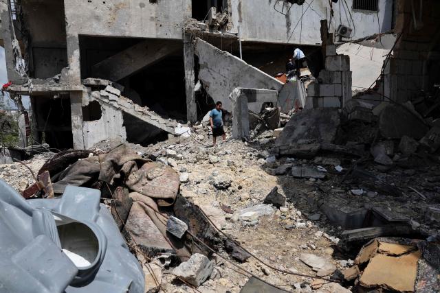 A young boy walks amid the rubble of a building destroyed in an Israeli strike in the southern Lebanese village of Kfar Sir on April 21, 2026. Israeli defence minister said on April 21 that his country's campaign in Lebanon relied on both military and diplomatic pressure to disarm Iran-allied Hezbollah. Though a truce between Israel and Lebanon took effect on April 17, Israeli troops are still present and actively fighting Hezbollah militants in Lebanon's south. (Photo by Anwar AMRO / AFP)