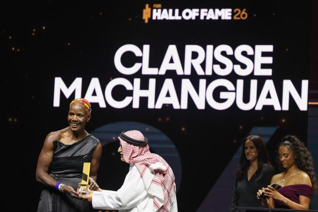 Mozambique basketball player Clarisse Machanguana (L) receives her award from President of the International Basketball Federation (FIBA) Sheikh Saud Ali Al Thani  atthe International Basketball Federation FIBA Hall of Fame 2026 Induction ceremony in Berlin on April 21, 2026. (Photo by Odd ANDERSEN / AFP)