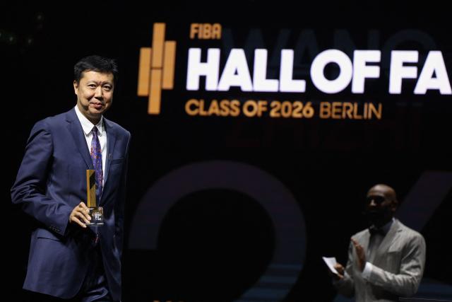 Chinese former basketball player Wang Zhizhi (L) receives his award at the International Basketball Federation FIBA Hall of Fame 2026 Induction ceremony in Berlin on April 21, 2026. (Photo by Odd ANDERSEN / AFP)