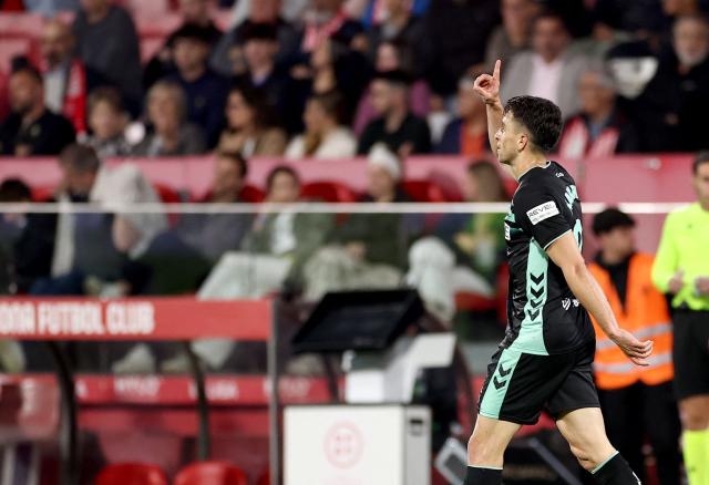 Real Betis' Spanish midfielder #21 Marc Roca celebrates scoring his team's first goal during the Spanish league football match between Girona FC and Real Betis at the Montilivi Stadium in Girona on April 21 , 2026. (Photo by Josep LAGO / AFP)