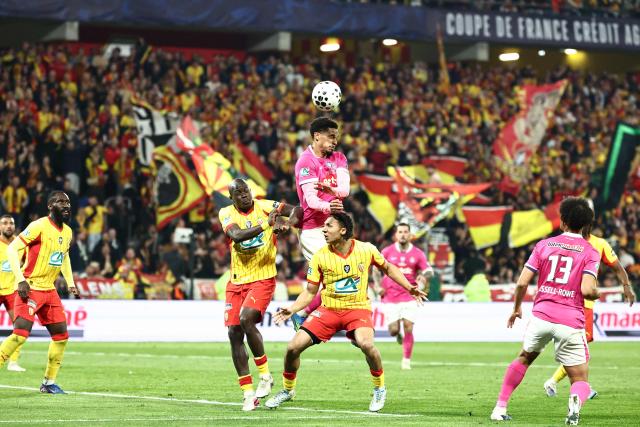 Toulouse's Brazilian forward #20 Emersonn heads the ball in front of Lens' French defender Pierre Ismaelo Ganiou and Lens' French defender #20 Malang Sarr during the French Cup semi-final football match between and RC Lens and Toulouse FC at the Stade Bollaert-Delelis in Lens, northern France on April 21, 2026. (Photo by Sameer AL-DOUMY / AFP)