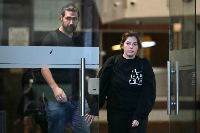 Dalma Maradona (R), daughter of Argentine football legend Diego Maradona, and her husband Andres Caldarelli (L) leave the court hall for a trial hearing on her father's death in San Isidro, Buenos Aires province, Argentina on April 21, 2026. Diego Maradona's daughter Gianinna on April 21, 2026, slammed what she called the "total manipulation' of the late player's family by his doctors in the lead-up to his death in 2020. (Photo by Juan MABROMATA / AFP)
