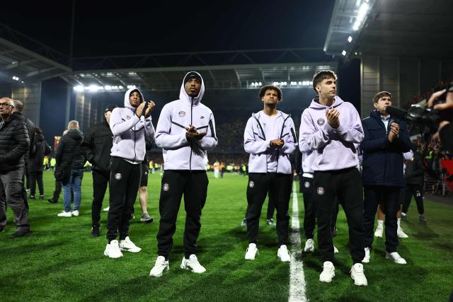 Toulouse's players greet their supporters at the end of the French Cup semi-final football match between and RC Lens and Toulouse FC at the Stade Bollaert-Delelis in Lens, northern France on April 21, 2026. (Photo by Sameer AL-DOUMY / AFP)
