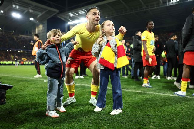 Lens' French defender #02 Ruben Aguilar celebrates their victory with children at the end of the French Cup semi-final football match between and RC Lens and Toulouse FC at the Stade Bollaert-Delelis in Lens, northern France on April 21, 2026. (Photo by Sameer AL-DOUMY / AFP)