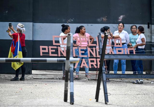 Relatives of inmates wait for news of their loved ones outside the Yare prison in San Francisco de Yare, Miranda state, Venezuela, on April 21, 2026. At least five inmates died in a riot at a maximum-security prison in Venezuela, officials said on April 21. The deaths occurred the previous day at the Yare III prison, about 70 kilometers (40 miles) outside the capital Caracas, when fighting among prisoners "escalated into a riot", the Ministry of Penitentiary Services said in a statement. (Photo by Maryorin Mendez / AFP)