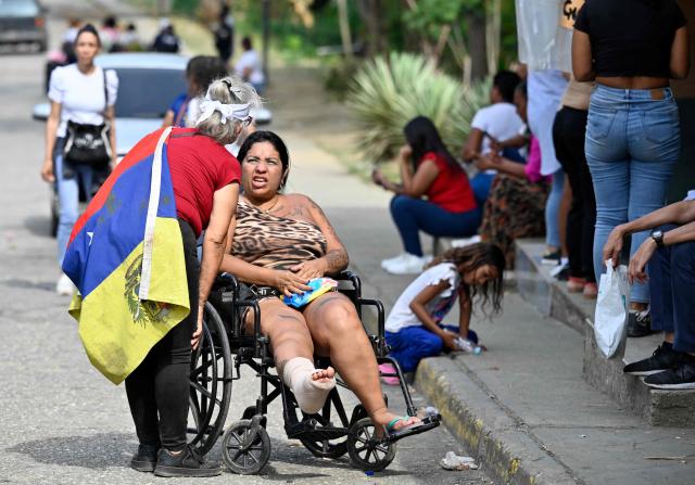 Relatives of inmates wait for news of their loved ones outside the Yare prison in San Francisco de Yare, Miranda state, Venezuela, on April 21, 2026. At least five inmates died in a riot at a maximum-security prison in Venezuela, officials said on April 21. The deaths occurred the previous day at the Yare III prison, about 70 kilometers (40 miles) outside the capital Caracas, when fighting among prisoners "escalated into a riot", the Ministry of Penitentiary Services said in a statement. (Photo by Maryorin Mendez / AFP)