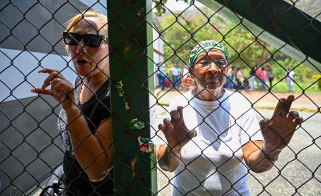 Relatives of inmates wait for news of their loved ones outside the Yare prison in San Francisco de Yare, Miranda state, Venezuela, on April 21, 2026. At least five inmates died in a riot at a maximum-security prison in Venezuela, officials said on April 21. The deaths occurred the previous day at the Yare III prison, about 70 kilometers (40 miles) outside the capital Caracas, when fighting among prisoners "escalated into a riot", the Ministry of Penitentiary Services said in a statement. (Photo by Maryorin Mendez / AFP)