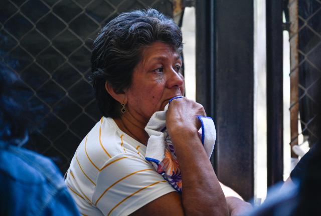 A relative of an inmate waits for news of her loved one outside the Yare prison in San Francisco de Yare, Miranda state, Venezuela, on April 21, 2026. At least five inmates died in a riot at a maximum-security prison in Venezuela, officials said on April 21. The deaths occurred the previous day at the Yare III prison, about 70 kilometers (40 miles) outside the capital Caracas, when fighting among prisoners "escalated into a riot", the Ministry of Penitentiary Services said in a statement. (Photo by Maryorin Mendez / AFP)