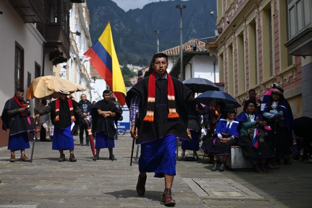 A Misak Indigenous man walks during a protest to demand compliance with agreements reached with the government regarding their territories outside the Ministry of Foreign Affairs in Bogota on April 21, 2026. (Photo by Raul ARBOLEDA / AFP)
