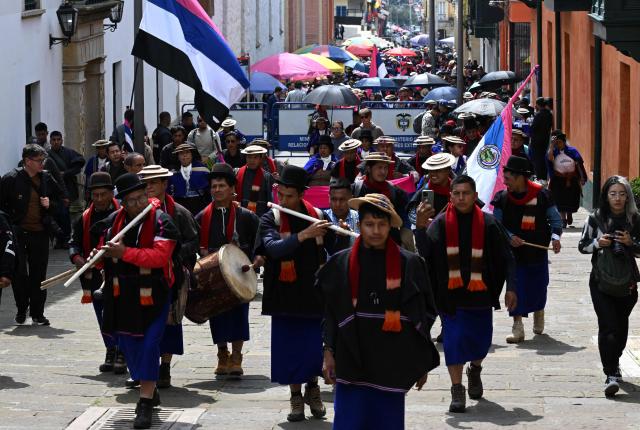 Misak Indigenous people protest to demand compliance with agreements reached with the government regarding their territories outside the Ministry of Foreign Affairs in Bogota on April 21, 2026. (Photo by Raul ARBOLEDA / AFP)