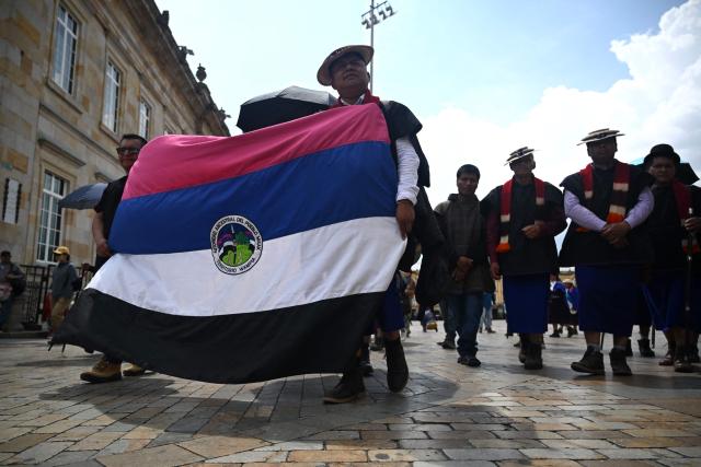 Misak Indigenous people protest to demand compliance with agreements reached with the government regarding their territories outside the Ministry of Foreign Affairs in Bogota on April 21, 2026. (Photo by Raul ARBOLEDA / AFP)