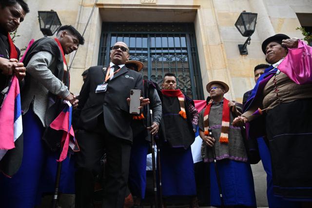 Misak Indigenous people block the entrance to the Ministry of Foreign Affairs during a protest to demand compliance with agreements reached with the government regarding their territories in Bogota on April 21, 2026. (Photo by Raul ARBOLEDA / AFP)