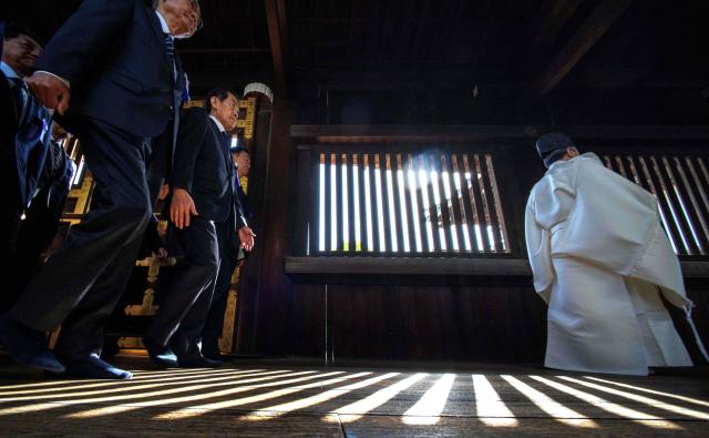 A Shinto priest leads parliament members to pray for the war dead at Yasukuni Shrine in Tokyo on April 22, 2026, as part of the shrine's three-day spring festival. (Photo by Kazuhiro NOGI / AFP)