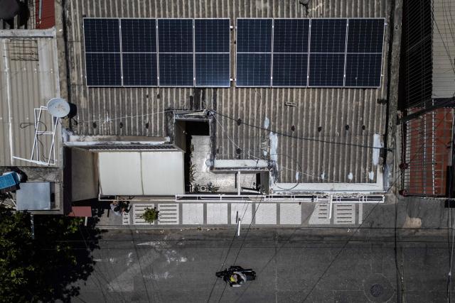 Aerial view of solar panels powering Hernan Sarmiento's grocery store in Santa Marta, Magdalena department, Colombia, on April 20, 2026. Colombia's President Gustavo Petro is driving a transformation towards clean energy, determined to reduce the country's dependence on fossil fuels—which, according to him, cause "destruction." (Photo by Luis ACOSTA / AFP)