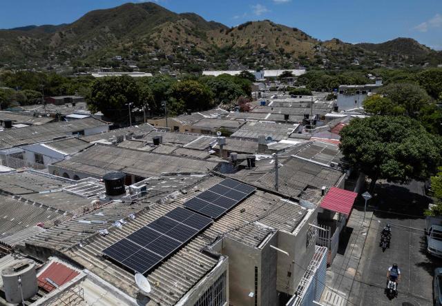 Aerial view of solar panels powering Hernan Sarmiento's grocery store in Santa Marta, Magdalena department, Colombia, on April 20, 2026. Colombia's President Gustavo Petro is driving a transformation towards clean energy, determined to reduce the country's dependence on fossil fuels—which, according to him, cause "destruction." (Photo by Luis ACOSTA / AFP)