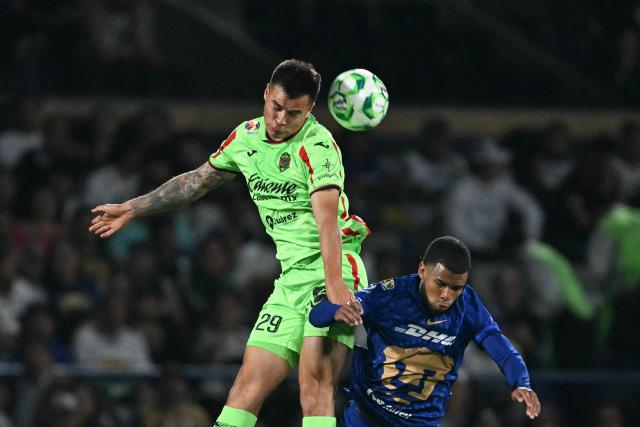 Juarez's forward #29 Ettson Ayon and Pumas' Ecuadorian midfielder #45 Pedro Vite jump to head the ball during a Pumas vs Juarez Mexican League football match in Mexico City on April 21, 2026. (Photo by YURI CORTEZ / AFP)