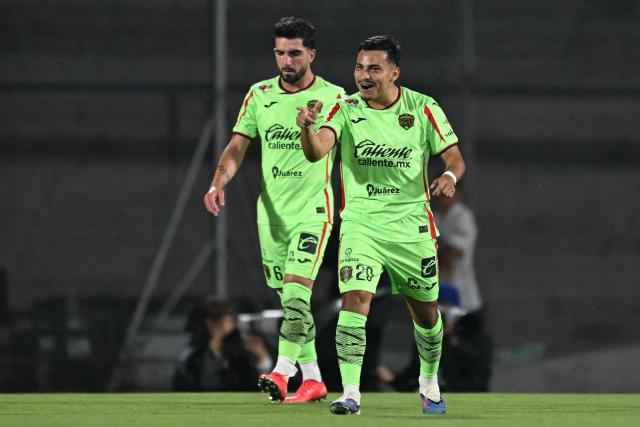 Juarez's forward #20 Jairo Torres (R) celebrates with teammate Spanish midfielder #06 Monchu after scoring during a Pumas vs Juarez Mexican League football match in Mexico City on April 21, 2026. (Photo by YURI CORTEZ / AFP)