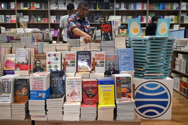 A man browses books at the International Book Fair in Bogota on April 21, 2026. (Photo by Raul ARBOLEDA / AFP)