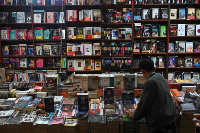 A man browses books at the International Book Fair in Bogota on April 21, 2026. (Photo by Raul ARBOLEDA / AFP)