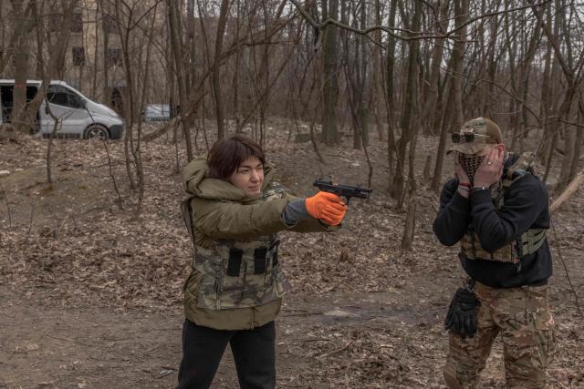 (FILES) A Ukrainian civilian woman practices with a weapon as she attends a training for women focused on the use of weapons and combat medical kit, in Kyiv, on March 16, 2024, amid the Russian invasion of Ukraine. Seven dead, police officers accused of fleeing the scene... April 19, 2026s bloody and extremely rare shooting in Kyiv is providing ammunition for those who advocate the legalisation of firearms in Ukraine, which they claim would ensure greater security in a nation already traumatised by the war with Russia. (Photo by Roman PILIPEY / AFP)
