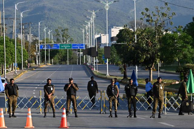 Police officers stand guard at a closed road leading to the Serena Hotel at the Red Zone area in Islamabad on April 22, 2026. Pakistani Prime Minister Shehbaz Sharif thanked US President Donald Trump on April 22, for extending a ceasefire with Iran that had been soon set to expire and urged both sides to continue talks. (Photo by Aamir QURESHI / AFP)