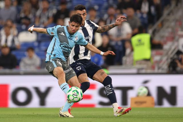 Puebla's winger #27 Bryan Garnica (L) and Monterrey's defender #21 Luis Reyes fight for the ball during a Monterrey vs Puebla Mexican League football match in Monterrey, Nuevo Leon state, Mexico, on April 21, 2026. (Photo by Julio Cesar AGUILAR / AFP)