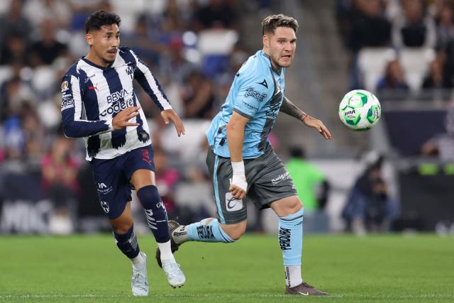Monterrey's defender #02 Ricardo Chavez and Puebla's Uruguayan forward #11 Emiliano Gomez fight for the ball during a Monterrey vs Puebla Mexican League football match in Monterrey, Nuevo Leon state, Mexico, on April 21, 2026. (Photo by Julio Cesar AGUILAR / AFP)