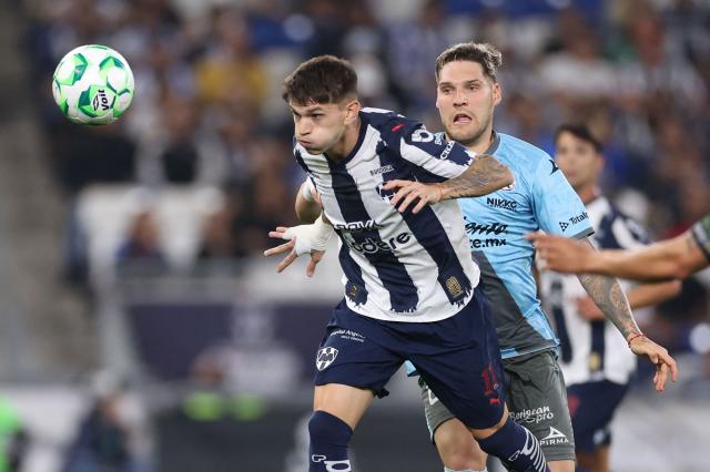 Monterrey's Argentine forward #11 Luca Orellano (L) and Puebla's Uruguayan forward #11 Emiliano Gomez fight for the ball during a Monterrey vs Puebla Mexican League football match in Monterrey, Nuevo Leon state, Mexico, on April 21, 2026. (Photo by Julio Cesar AGUILAR / AFP)