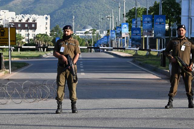 Police officers stand guard at a closed road leading to the Serena Hotel at the Red Zone area in Islamabad on April 22, 2026. Pakistani Prime Minister Shehbaz Sharif thanked US President Donald Trump on April 22, for extending a ceasefire with Iran that had been soon set to expire and urged both sides to continue talks. (Photo by Aamir QURESHI / AFP)