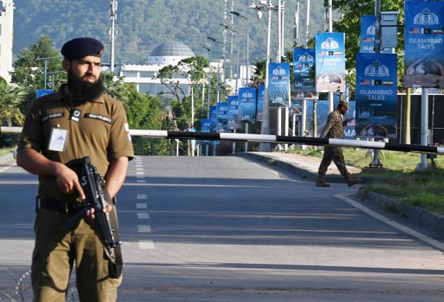 Police officers stand guard at a closed road leading to the Serena Hotel at the Red Zone area in Islamabad on April 22, 2026. Pakistani Prime Minister Shehbaz Sharif thanked US President Donald Trump on April 22, for extending a ceasefire with Iran that had been soon set to expire and urged both sides to continue talks. (Photo by Aamir QURESHI / AFP)
