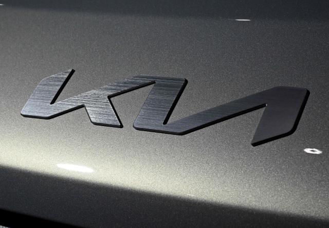 The logo of Kia is seen on its EV5 electric car during the 2026 World IT Show in Seoul on April 22, 2026. (Photo by Jung Yeon-je / AFP)