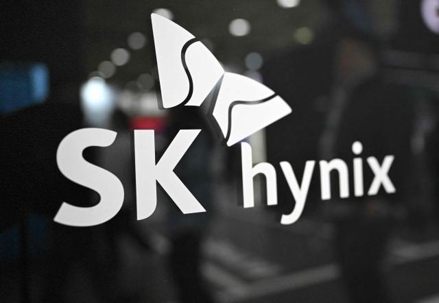 The logo of SK hynix is displayed on a glass wall during the 2026 World IT Show in Seoul on April 22, 2026. (Photo by Jung Yeon-je / AFP)