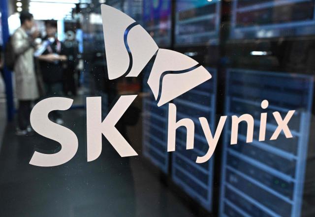 The logo of SK hynix is displayed on a glass wall during the 2026 World IT Show in Seoul on April 22, 2026. (Photo by Jung Yeon-je / AFP)
