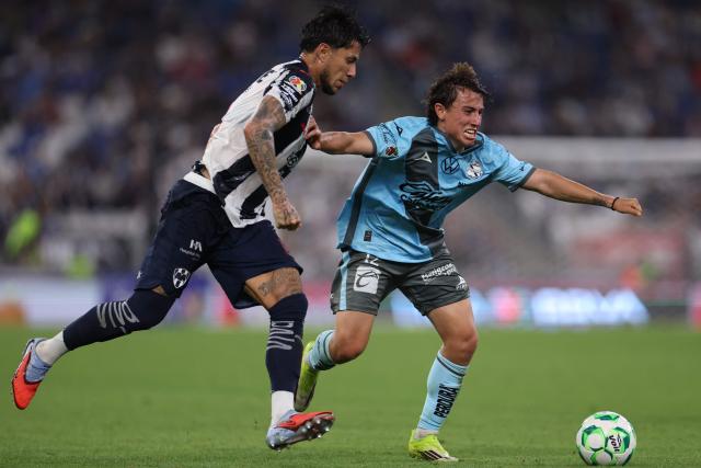 Monterrey's defender #13 Carlos Salcedo and Puebla's midfielder #12 Iker Moreno fight for the ball during a Monterrey vs Puebla Mexican League football match in Monterrey, Nuevo Leon state, Mexico, on April 21, 2026. (Photo by Julio Cesar AGUILAR / AFP)