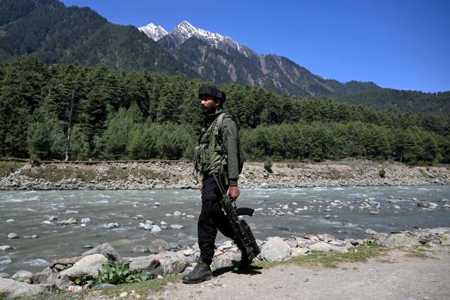 An Indian paramilitary personnel patrols along the banks of Lidder river in Pahalgam, in south Kashmir's Anantnag district on April 22, 2026 that marks the first anniversary of the Pahalgam attack which killed 26 men, mostly Hindu tourists. (Photo by Tauseef MUSTAFA / AFP)