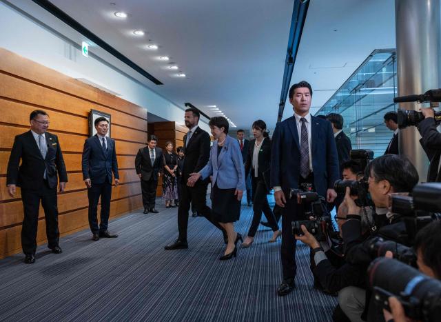 Japan's Prime Minister Sanae Takaichi (centre R) guides Montenegro's President Jakov Milatovic (centre L) before a meeting at the prime minister's office in Tokyo on April 22, 2026. (Photo by Andrew CABALLERO-REYNOLDS / AFP)