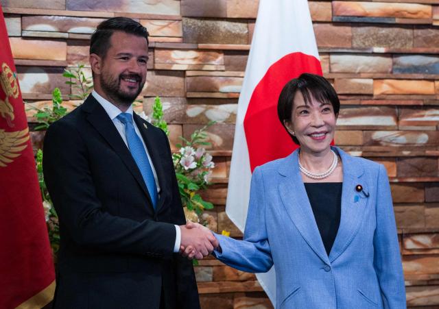 Japan's Prime Minister Sanae Takaichi (R) shakes hands with Montenegro's President Jakov Milatovic (L) before a meeting at the prime minister's office in Tokyo on April 22, 2026. (Photo by Andrew CABALLERO-REYNOLDS / AFP)